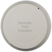 A white, ceiling-mounted smoke detector with the text 'Remote Test Capable' printed on it.